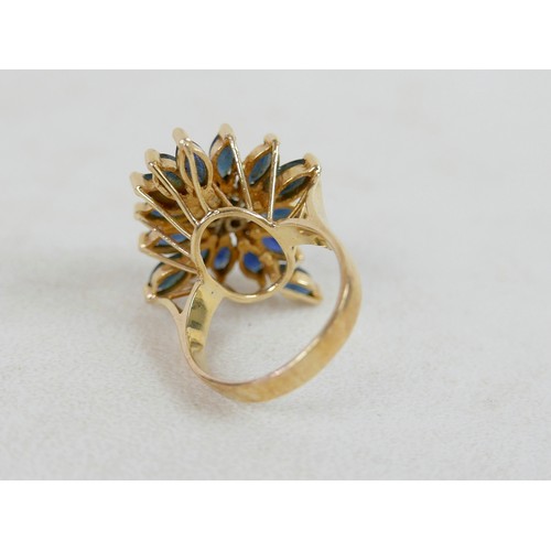57 - A large 14k gold, sapphire and diamond dress ring, marked 585, with flowerhead of marquise cut sapph... 
