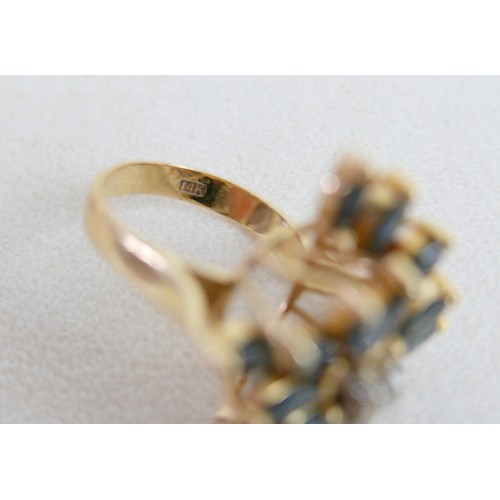 57 - A large 14k gold, sapphire and diamond dress ring, marked 585, with flowerhead of marquise cut sapph... 