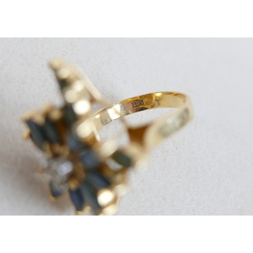 57 - A large 14k gold, sapphire and diamond dress ring, marked 585, with flowerhead of marquise cut sapph... 