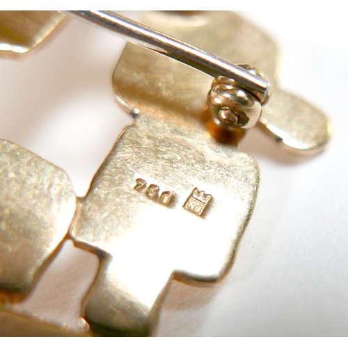 5 - An 18ct yellow gold abstract design brooch part textured marked NM, 57 by 32mm, 15.2g.