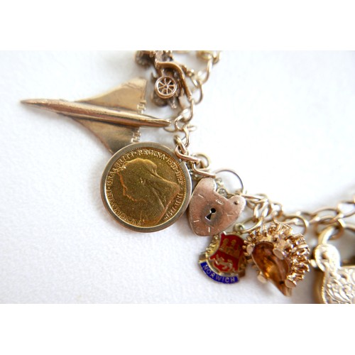8 - A 9ct gold charm bracelet with assorted charms and a Victoria, veiled head, 1896 half sovereign, 63.... 