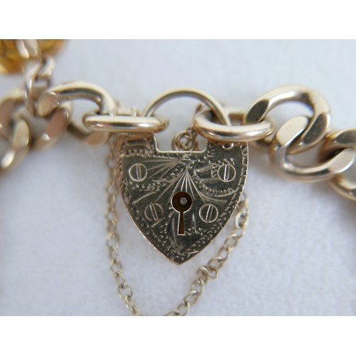 1 - A 9ct gold charm bracelet, flat curb, with assorted 9ct and 14ct gold charms including dolphins, bib... 