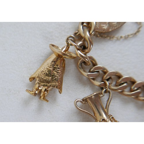 1 - A 9ct gold charm bracelet, flat curb, with assorted 9ct and 14ct gold charms including dolphins, bib... 