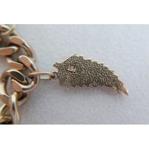 1 - A 9ct gold charm bracelet, flat curb, with assorted 9ct and 14ct gold charms including dolphins, bib... 