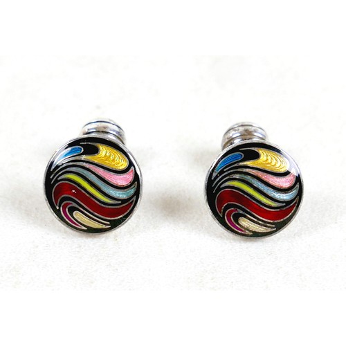 18 - A pair of modern silver cufflinks, ball return style with circular fronts decorated in a swirling de... 
