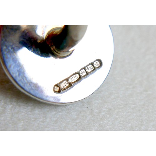 18 - A pair of modern silver cufflinks, ball return style with circular fronts decorated in a swirling de... 