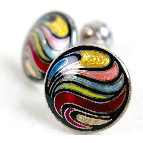 18 - A pair of modern silver cufflinks, ball return style with circular fronts decorated in a swirling de... 