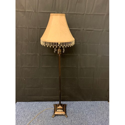 25 - Metal floor lamp with bead decoration on shade.