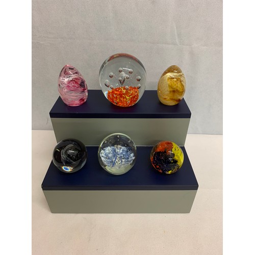 39 - 6 glass paperweights on stand.