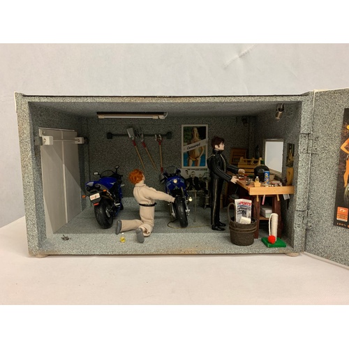 237 - Mock up of street motorbike garage with props, posters, motorbikes, figure etc. Has electrics. 22x38... 