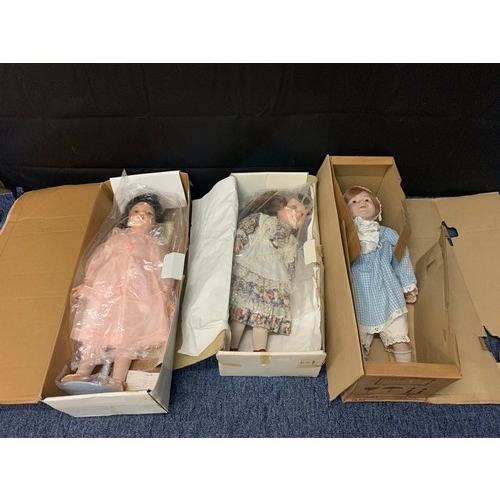 349 - 3 boxed porelain dolls.