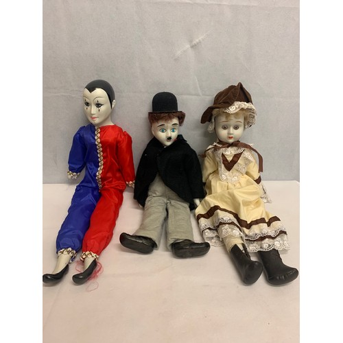 447 - Vintage porcelain dolls to include Charlie Chaplin.