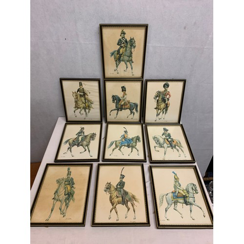 52 - 10 framed military pictures of soldiers on horses.