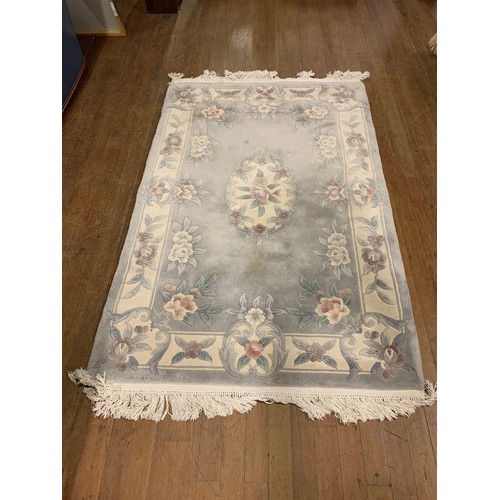 135 - Grey, floral floor rug.