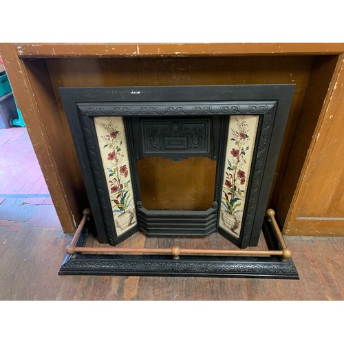 139 - Vintage cast iron fire place decorated with hand painted tiles along with fender.