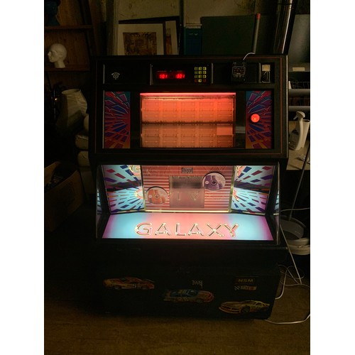 143 - NSM Galaxy CD juke box, holds 100 CD'S in excellent working condition. Includes remote control and k... 