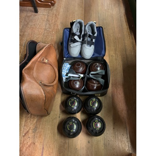 120 - Two sets of lawn bowls, shoes and bags.