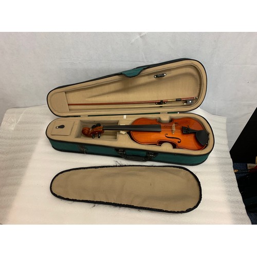 124 - Violin and case.