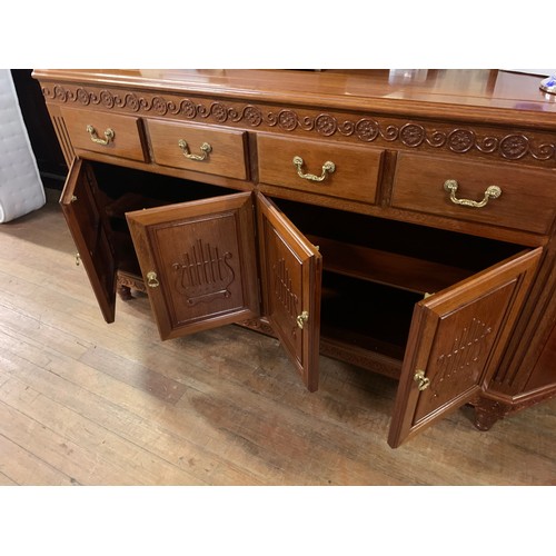 209 - Large rosewood 4 drawer/4 door sideboard/cabinet with brass fittings.