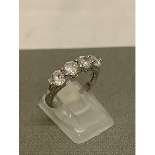 307 - Silver and diamante 3 stone dress ring.