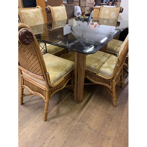 87 - Large bespoke glass top dining table on bamboo legs with 6 upholstered bamboo chairs.