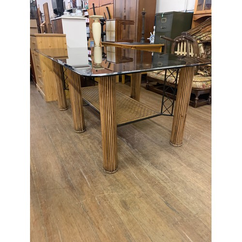 87 - Large bespoke glass top dining table on bamboo legs with 6 upholstered bamboo chairs.