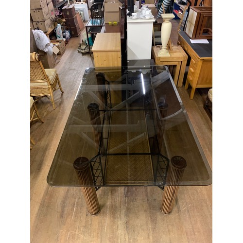 87 - Large bespoke glass top dining table on bamboo legs with 6 upholstered bamboo chairs.