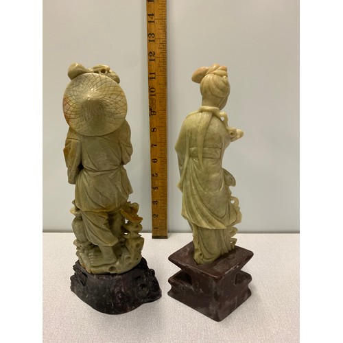 115 - Pair of large Oriental soap stone figures on wooden stands.