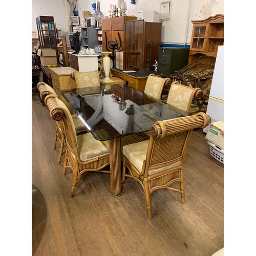 148 - Large bespoke glass top dining table on bamboo legs with 6 upholstered bamboo chairs.