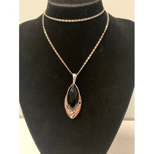 218 - Long silver chain with large black stone pendant.