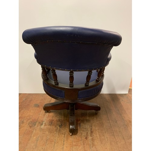 58 - Mahogany framed antique captains chair upholstered in blue leather.