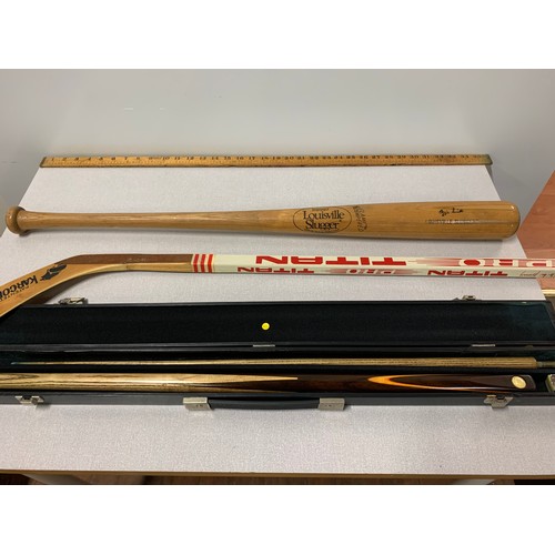 87 - Louisville Slugger baseball bat, hockey stick and pool cue in case.