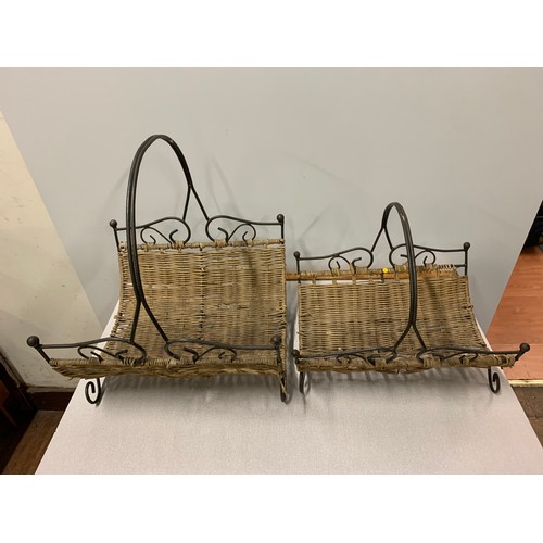 109 - Two wicker and wrought iron fireside log holders.
