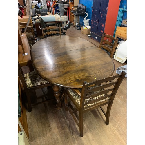 135 - Ercol extending dining table and 4 chairs (2 carvers).