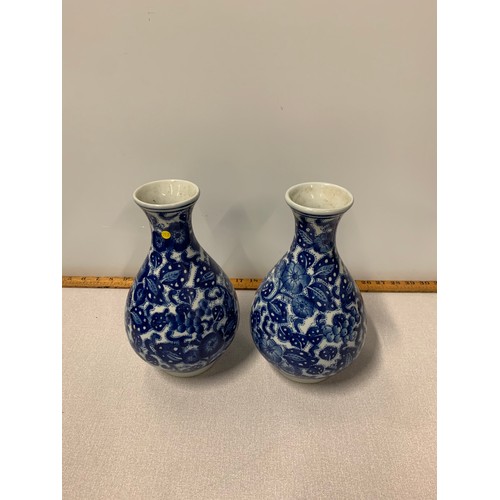 188 - Pair of blue and white Oriental vases. Marked to base. 26cm tall