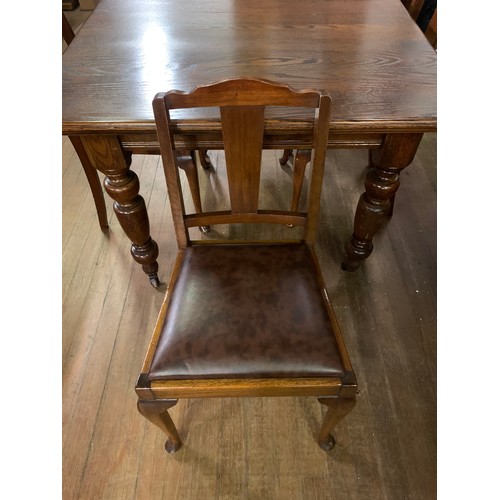 220 - Vintage wooden dining table on casters with 4 matching chairs.