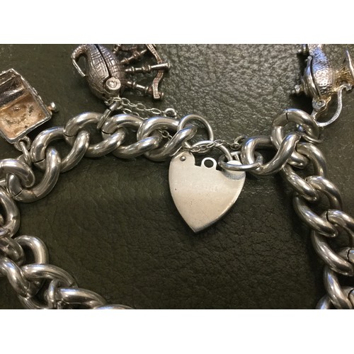 250 - Hallmarked silver charm bracelet with 10 charms and heart lock.