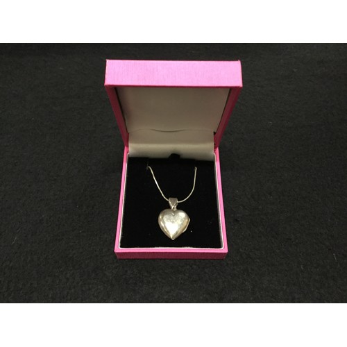 212 - Hallmarked silver chain and heart locket.