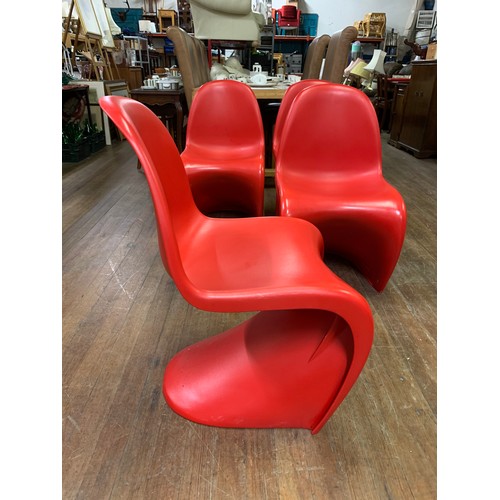 344 - 4 x Retro, red plastic stacking chairs in the style of Verner Panton for Herman Miller.