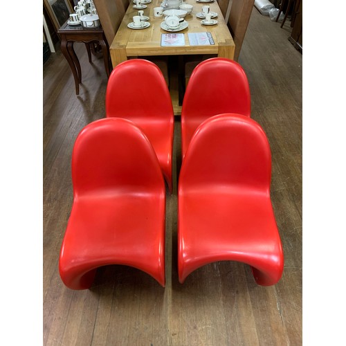 344 - 4 x Retro, red plastic stacking chairs in the style of Verner Panton for Herman Miller.