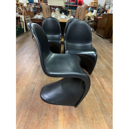 345 - 4 x Retro, black plastic stacking chairs in the style of Verner Panton for Herman Miller.