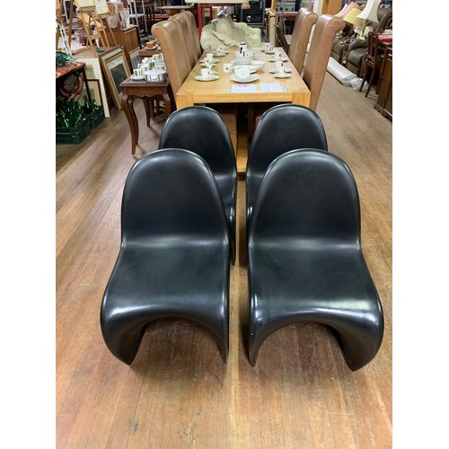 345 - 4 x Retro, black plastic stacking chairs in the style of Verner Panton for Herman Miller.