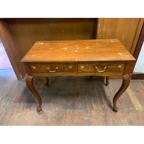 471 - Solid wood table 2 drawer table with floral design brass inlay on Queen Anne legs.
77cm h x 104cm h ... 