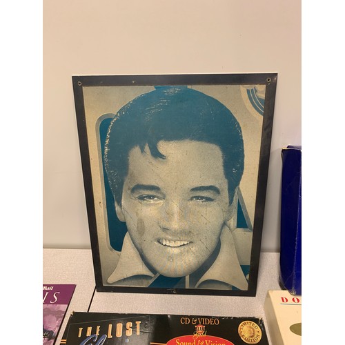 82 - Collection of Elvis memorabilia to include dvds, cd's and boxed aftershave set etc.