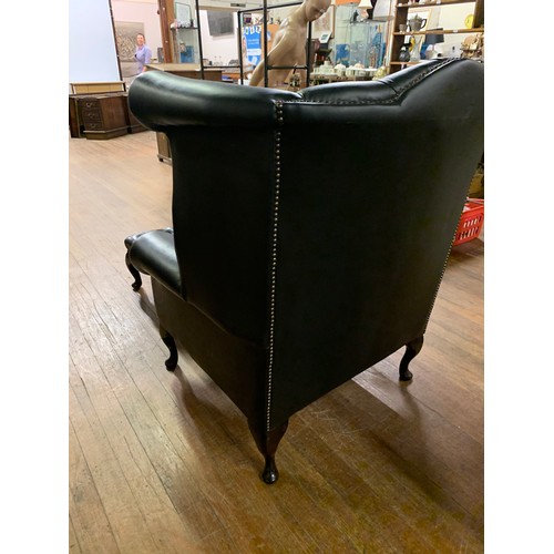 93 - Black leather Chesterfield, wing back chair and stool.