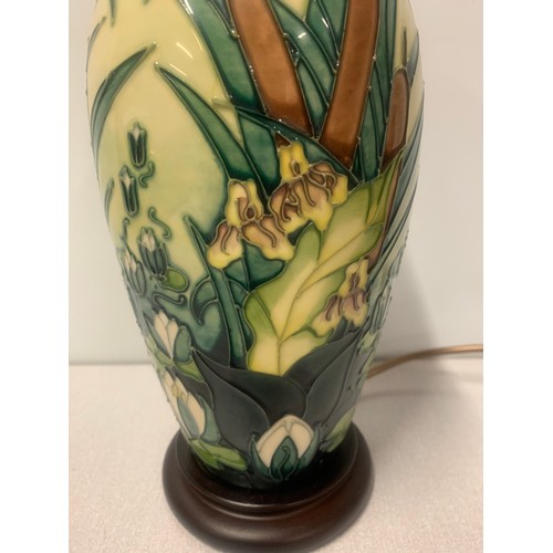 130 - Moorcroft lamp base with irises and reeds etc on a pale yellow background mounted on a circular wood... 