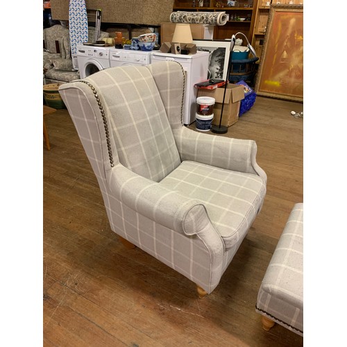 209 - Upholstered next wingback chair with matching stool.