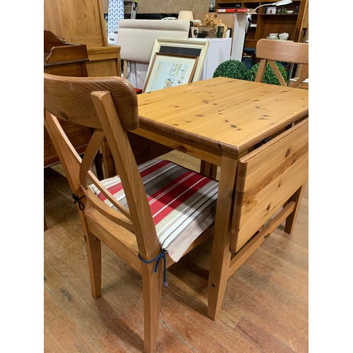 210 - Pine drop-leaf dining table and 2 chairs.