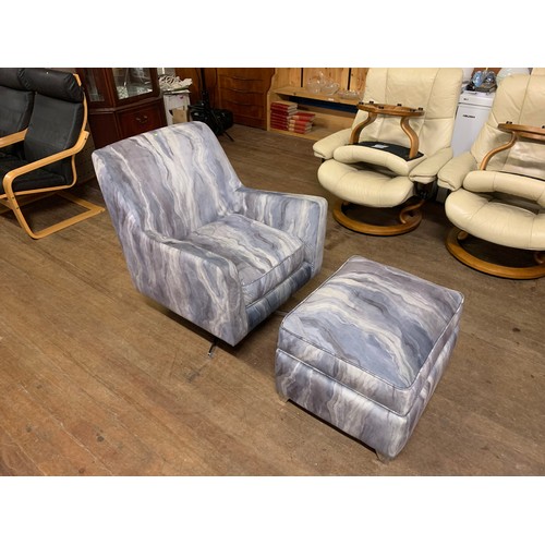 29 - Retro swivel armchair with matching stool with watercolour/tie-dye style upholstery.