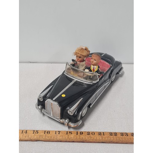 61 - Vintage metal electric car with figures in working order.
Approx 31cm Long